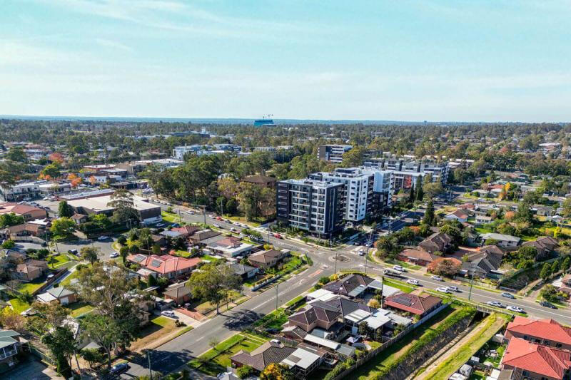 An overhead image of a community with housing, trees and parks